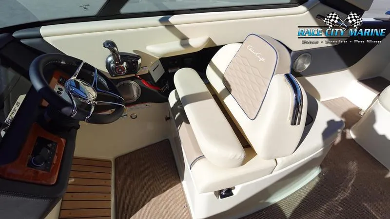 Slide: The Image of 2025 Chris-Craft Sportster boat interior with steering wheel and cushioned seating. - 28
