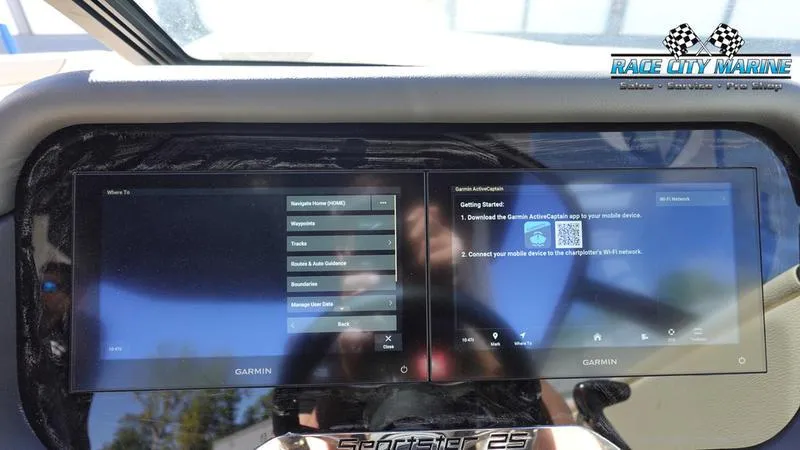 Slide: The Image of 2025 Chris-Craft Sportster dashboard with dual Garmin screens displaying navigation and setup options. - 34