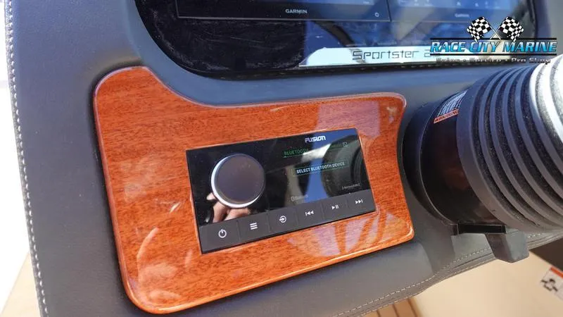 Slide: The Image of Dashboard of 2025 Chris-Craft Sportster with Fusion audio system and wood paneling. - 35
