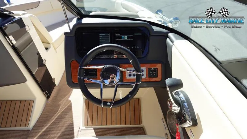 Slide: The Image of 2025 Chris-Craft Sportster boat interior with modern dashboard and steering wheel. - 36