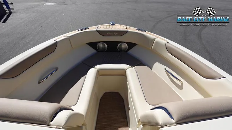 Slide: The Image of 2025 Chris-Craft Sportster boat interior with beige seating and Race City Marine logo. - 37