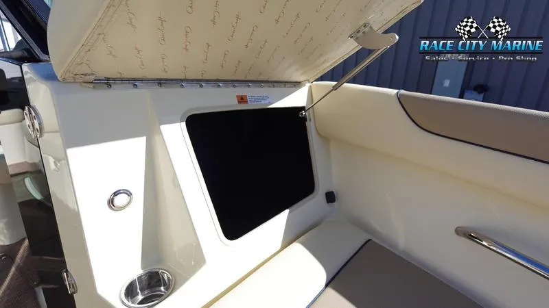 Slide: The Image of 2025 Chris-Craft Sportster interior storage compartment with Race City Marine branding. - 39