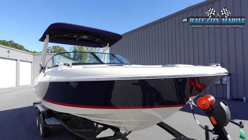 Slide: The Image of 2025 Chris-Craft Sportster boat on trailer at Race City Marine dealership. - 4