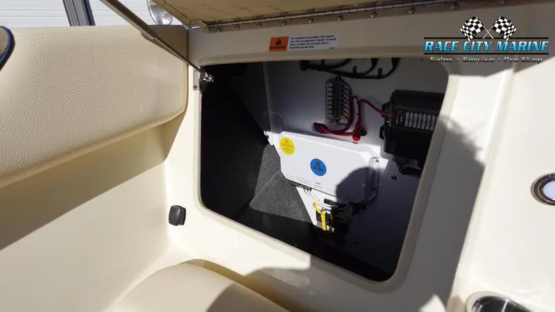 Slide: The Image of 2025 Chris-Craft Sportster interior storage compartment with visible wiring and components. - 40