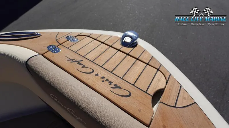 Slide: The Image of 2025 Chris-Craft Sportster boat deck with wood finish, Race City Marine logo. - 43
