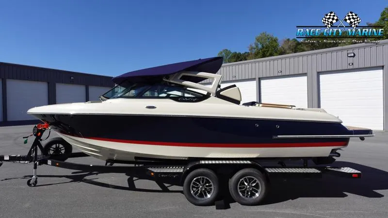 Slide: The Image of 2025 Chris-Craft Sportster boat on trailer at Race City Marine dealership. - 48