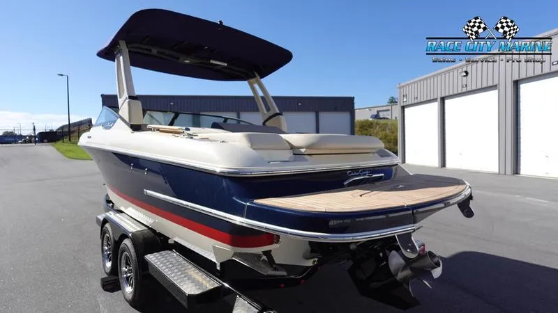 Slide: The Image of 2025 Chris-Craft Sportster boat on trailer, parked outside Race City Marine. - 6