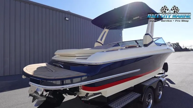 Slide: The Image of 2025 Chris-Craft Sportster boat on trailer, sleek design, blue and white color scheme. - 7