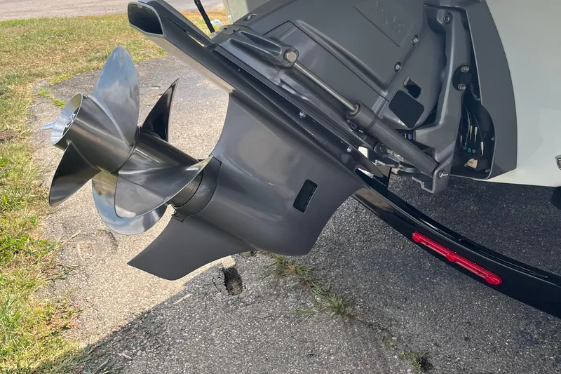 Slide: The Image of 2025 Crownline Eclipse E235 boat propeller and outdrive on pavement. - 22