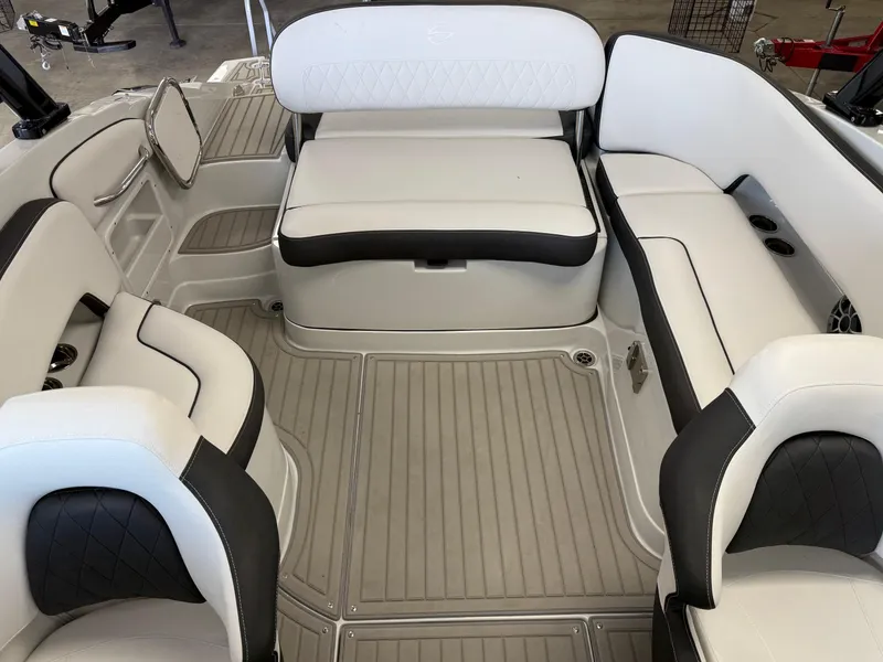Slide: The Image of 2025 Crownline Eclipse E235 boat interior with sleek black and white seating and modern dashboard. - 8
