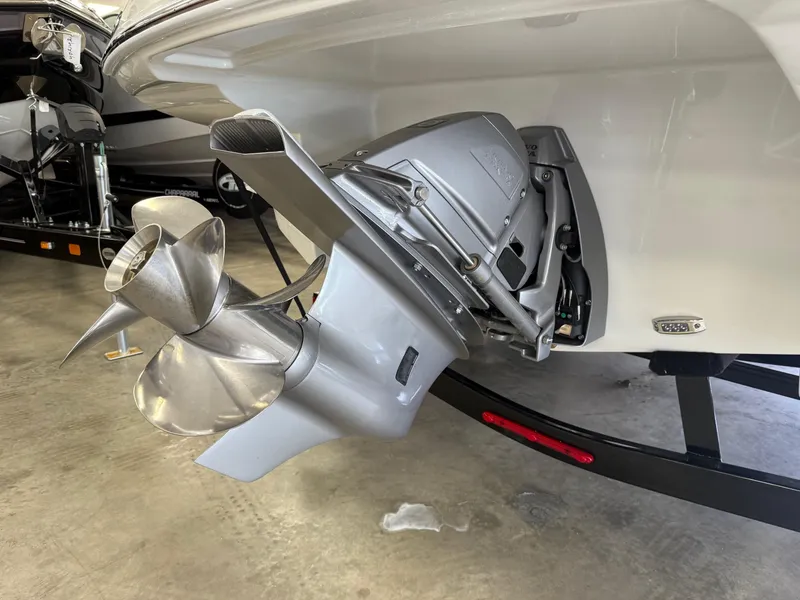 Slide: The Image of 2025 Crownline Eclipse E235 boat dashboard with steering wheel and control panel. - 9