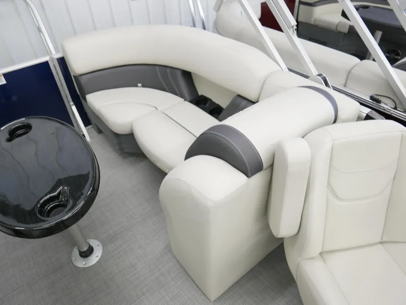 Slide: The Image of 2025 Sylvan Mirage 8520 LZ boat interior with plush seating and sleek table design. - 14