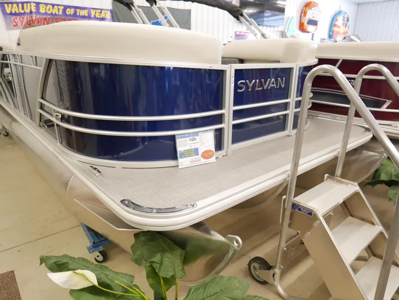 Slide: The Image of 2025 Sylvan Mirage 8520 LZ pontoon boat on display with award signage. - 2