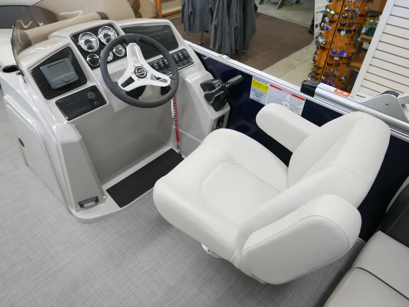 Slide: The Image of 2025 Sylvan Mirage 8520 LZ boat cockpit with steering wheel and captain's chair. - 9
