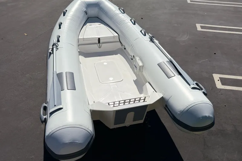 Slide: The Image of Inflatable boat Caribe MVP11 2025 model on asphalt surface, showcasing sleek design and durable construction. - 15