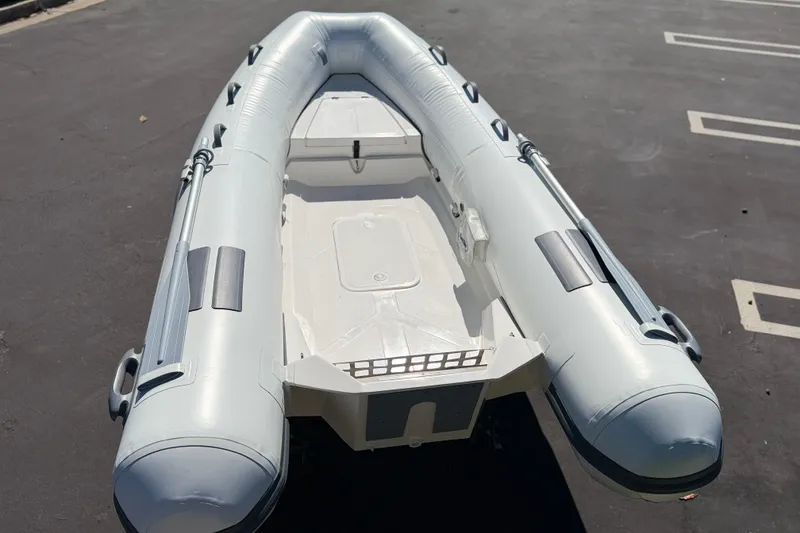 Slide: The Image of Inflatable boat Caribe MVP11 2025 model, parked on asphalt surface. - 16