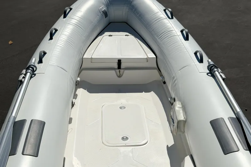 Slide: The Image of Inflatable boat interior, Caribe MVP11, 2025 model, featuring durable design and storage compartment. - 17