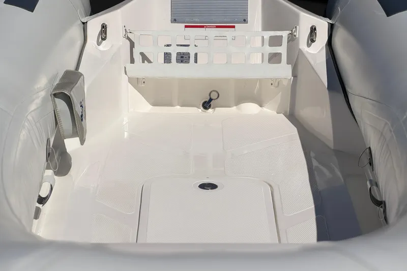 Slide: The Image of Interior view of 2025 Caribe MVP11 boat, featuring sleek white design and spacious layout. - 21