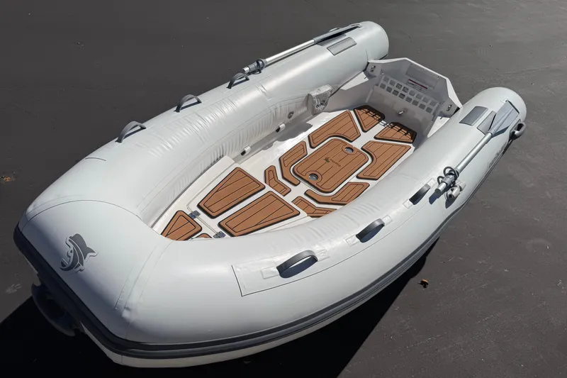 Slide: The Image of Inflatable boat Caribe MVP11 2025 model with wooden floor accents. - 28
