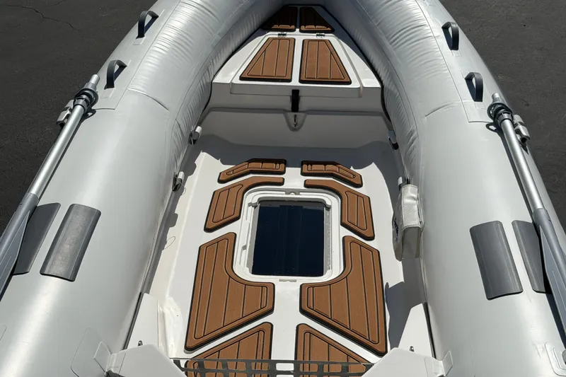 Slide: The Image of Inflatable boat interior with wood accents, Caribe MVP11, 2025 model. - 31
