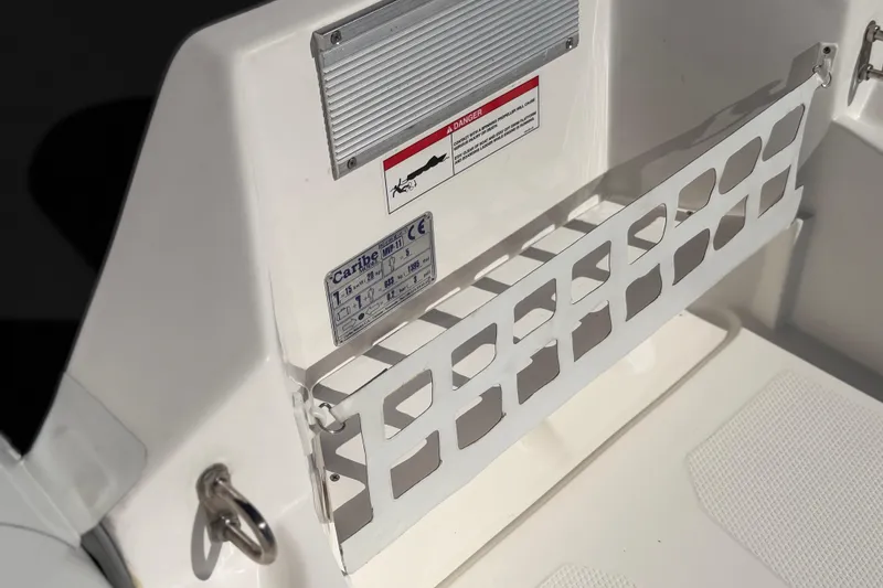 Slide: The Image of Interior detail of 2025 Caribe MVP11 boat with safety features and storage compartment. - 4