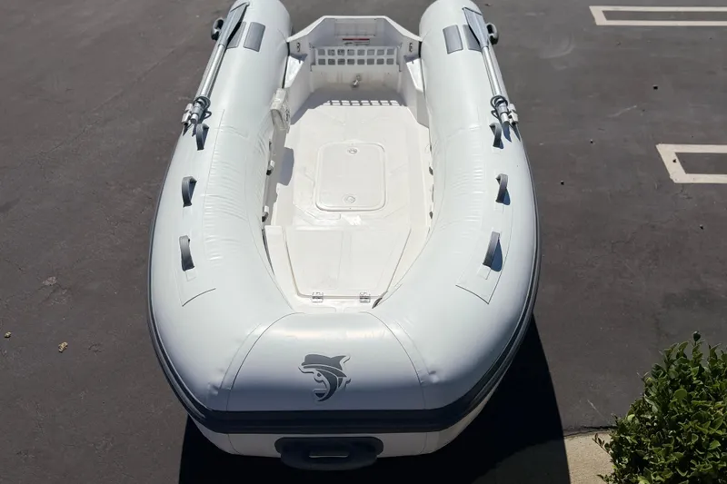 Slide: The Image of Inflatable boat Caribe MVP11 2025 model on pavement, featuring sleek design and durable materials. - 8