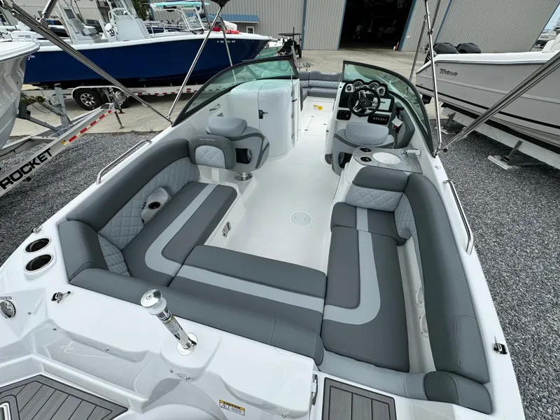 Slide: The Image of 2025 NauticStar 243 DC Deck boat with spacious seating and modern design. - 12