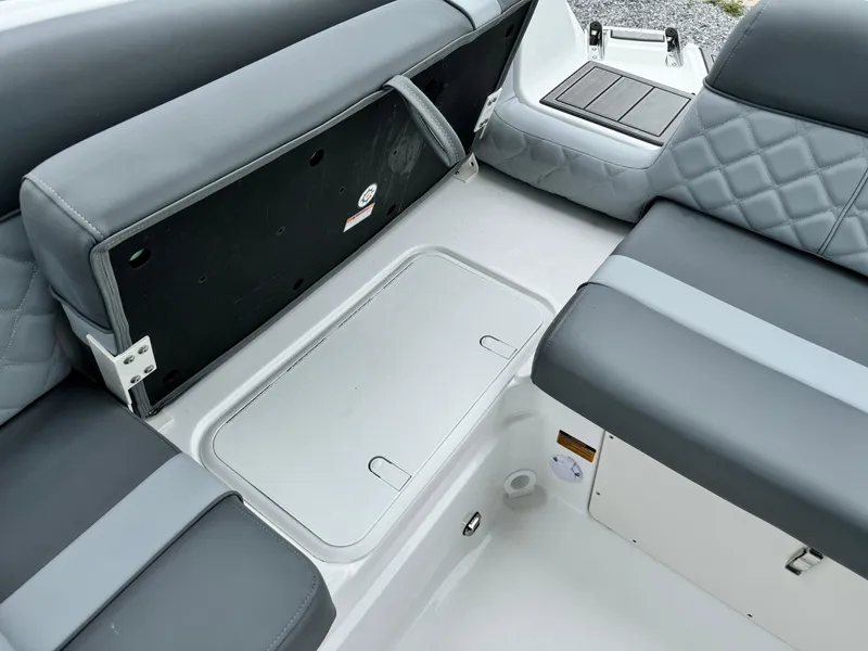 Slide: The Image of 2025 NauticStar 243 DC Deck boat interior seating and storage area. - 15