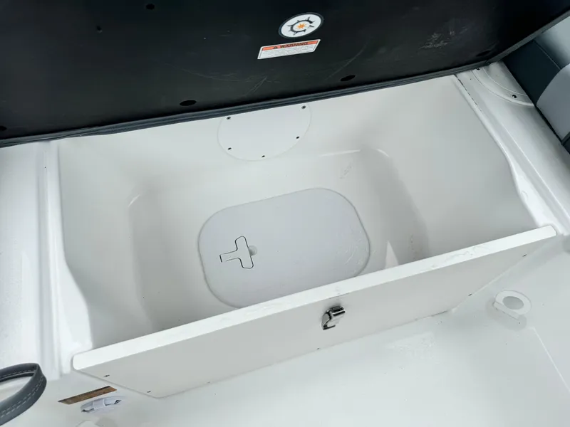 Slide: The Image of 2025 NauticStar 243 DC Deck boat storage compartment, open and empty. - 16