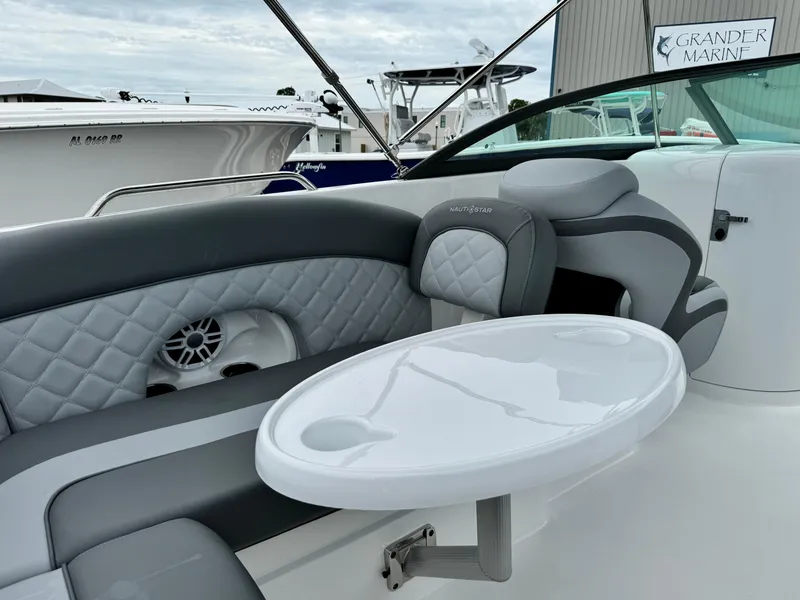 Slide: The Image of 2025 NauticStar 243 DC Deck boat interior with seating and table. - 17