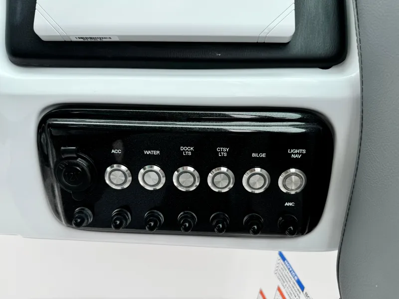 Slide: The Image of Control panel of 2025 NauticStar 243 DC Deck boat with labeled switches. - 20