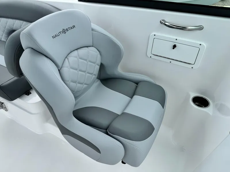 Slide: The Image of 2025 NauticStar 243 DC Deck boat seat, gray and white upholstery, luxurious design. - 22