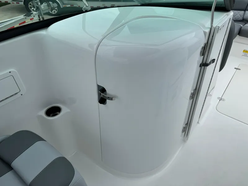 Slide: The Image of 2025 NauticStar 243 DC Deck boat interior with sleek white finish and seating area. - 23