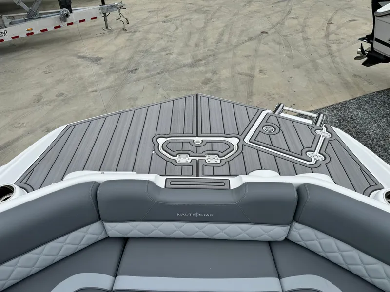 Slide: The Image of 2025 NauticStar 243 DC Deck boat with stylish gray seating and deck design. - 28