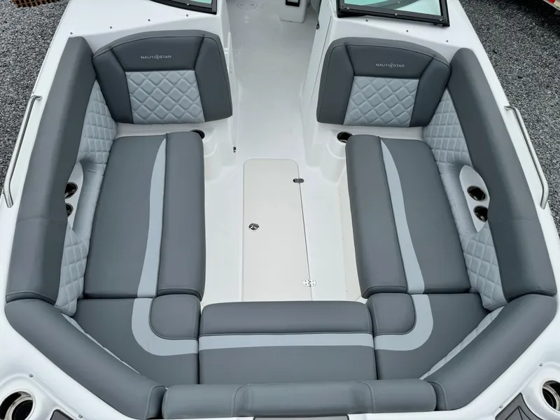 Slide: The Image of 2025 NauticStar 243 DC Deck boat interior with gray cushioned seating. - 29