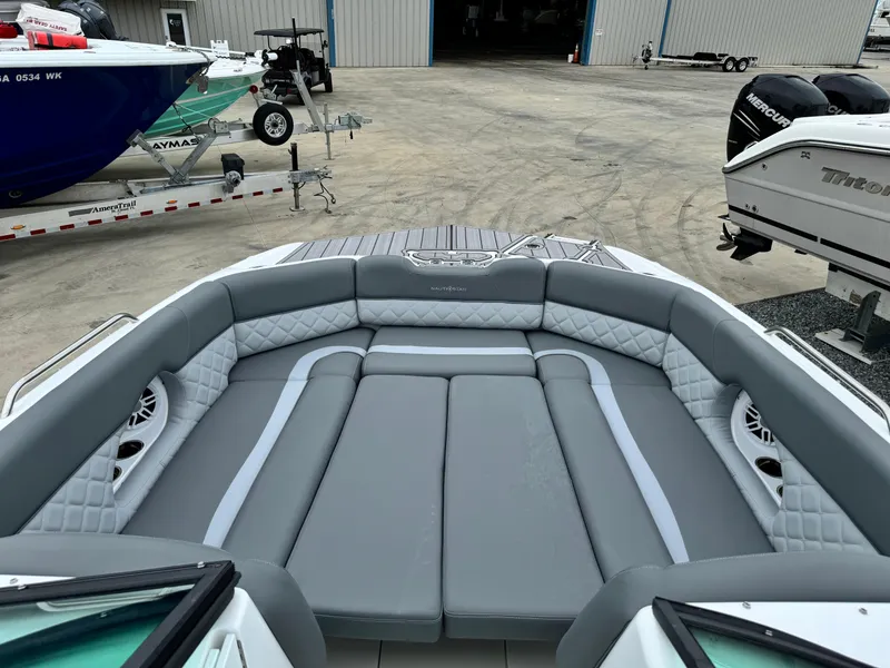 Slide: The Image of 2025 NauticStar 243 DC Deck boat with spacious seating and modern design. - 30