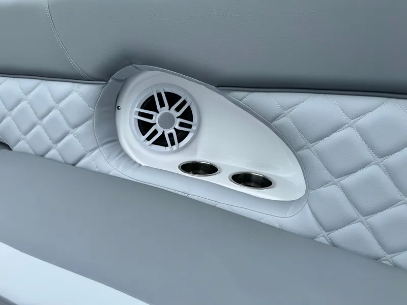 Slide: The Image of 2025 NauticStar 243 DC Deck boat interior with speaker and cup holders. - 33