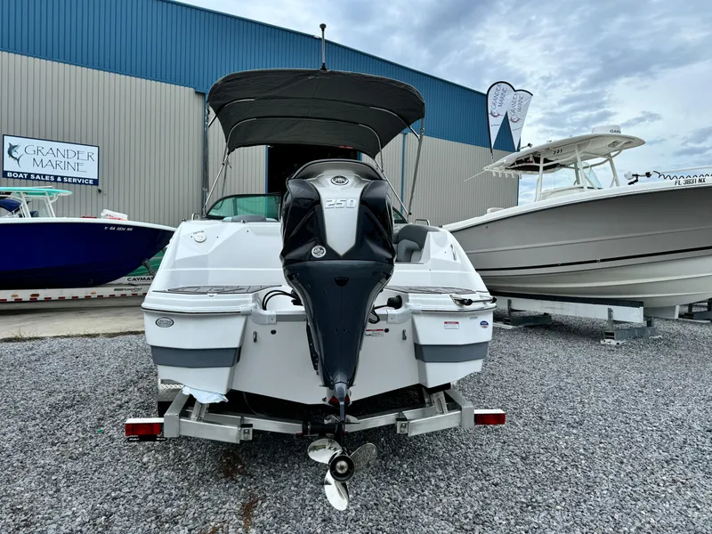 Slide: The Image of 2025 NauticStar 243 DC Deck boat with outboard motor at marina. - 4
