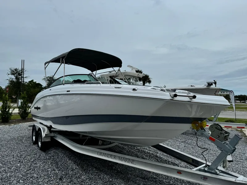 Slide: The Image of 2025 NauticStar 243 DC Deck boat on trailer, sleek design, ready for adventure. - 8
