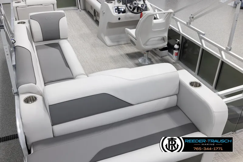 Slide: The Image of 2025 Avalon VENT CRB boat interior with gray and white seating, steering console, and cup holders. - 12