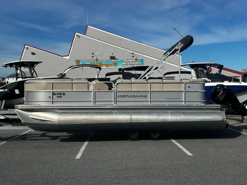 Slide: The Image of 2018 Berkshire 22CL CTS pontoon boat parked in a marina lot. - 0