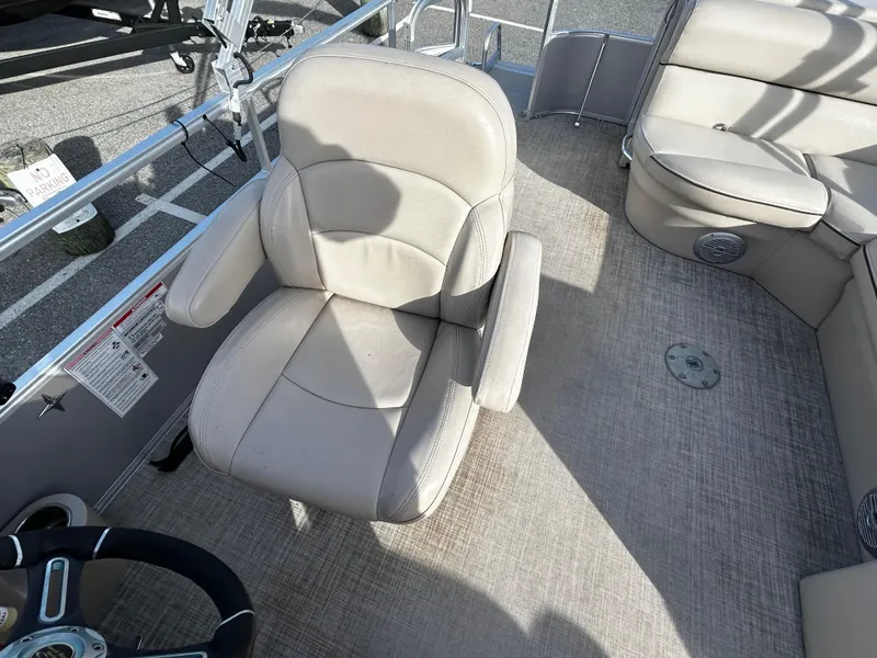 Slide: The Image of 2018 Berkshire 22CL CTS boat interior with beige seating and steering wheel. - 11