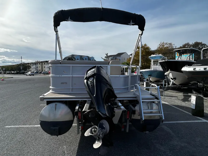 Slide: The Image of 2018 Berkshire 22CL CTS pontoon boat with outboard motor in a parking lot. - 13