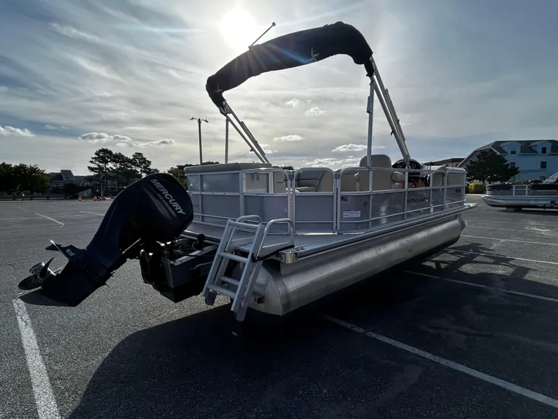 Slide: The Image of 2018 Berkshire 22CL CTS pontoon boat with Mercury outboard in parking lot. - 2