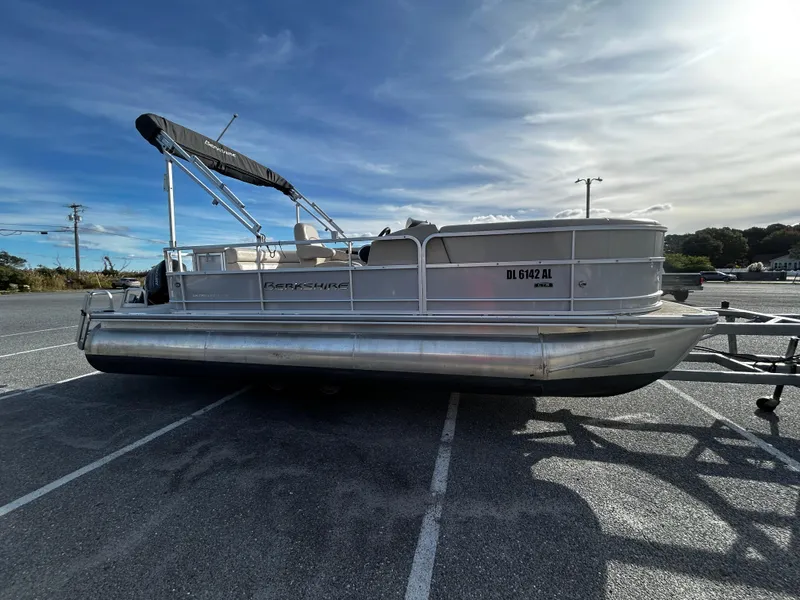 Slide: The Image of 2018 Berkshire 22CL CTS pontoon boat parked in a lot under a blue sky. - 4