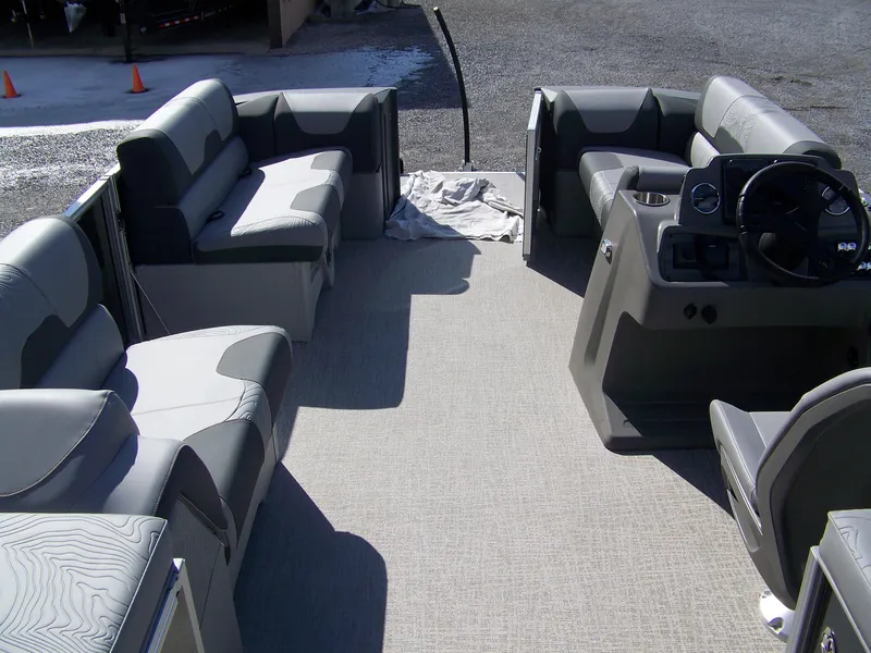 Slide: The Image of 2025 Avalon GeoFish23RF pontoon boat interior with gray seating and steering console. - 14