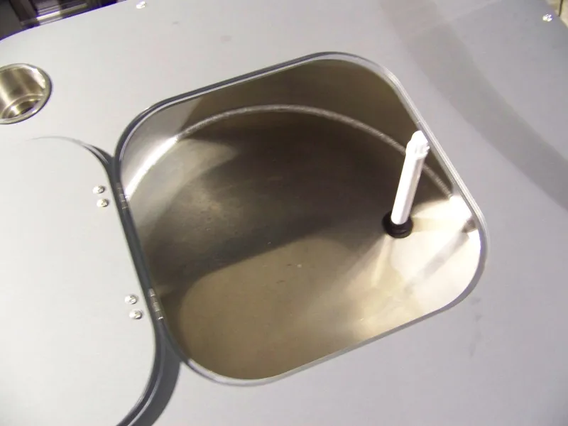 Slide: The Image of Avalon GeoFish23RF 2025 livewell interior with open lid and water intake. - 7