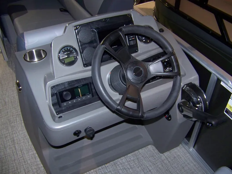 Slide: The Image of 2025 Avalon GeoFish23RF boat dashboard with steering wheel and controls. - 8
