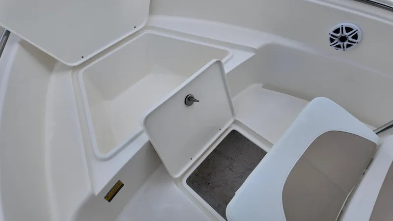 Slide: The Image of 2025 Bulls Bay 200CC boat interior with open storage compartments and speaker. - 13