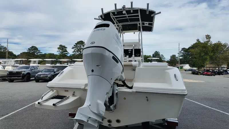 Slide: The Image of 2025 Bulls Bay 200CC boat with powerful outboard motor, parked outdoors. - 4